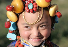 A child wears traditional costume during the Tibetan Kangba Art Festival in Yushu county, northwest China's Qinghai province July 25, 2007. The five-day art festival provides visitors with folk performances, costume displays and horse racings, local media reported. Picture taken July 25, 2007.