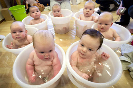 Babies enjoy bath in tubs